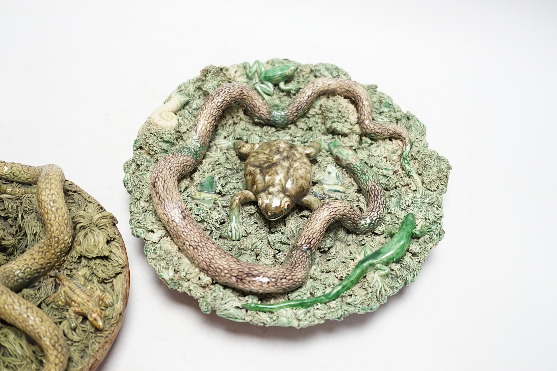 Two Caldas Palissy ware dishes decorated with frogs, snakes and a lizard, the larger 24cm diameter